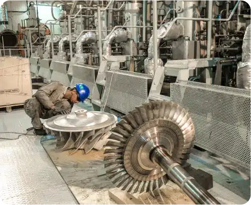 A Majestic Engineering employee balances and re-blades a turbocharger in protective gear.
