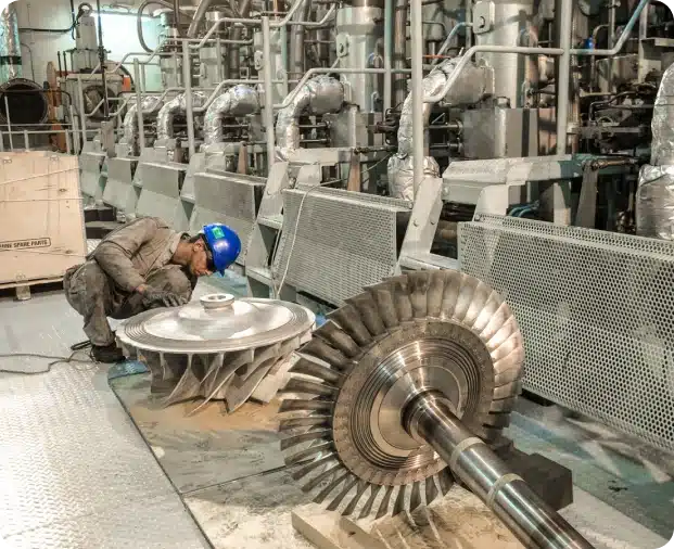 A Majestic Engineering technician in safety gear is re-blading turbocharger turbine rotors.
